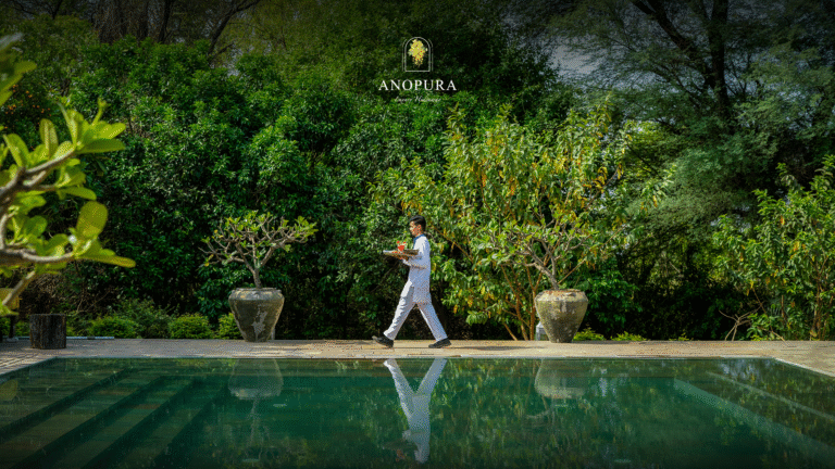 Resort staff walking beside peaceful forest poolside retreat